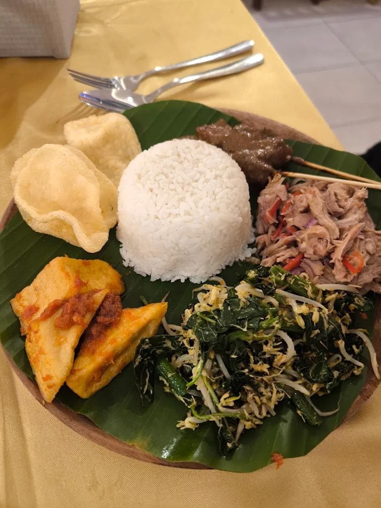 Authentic chicken Ayam Betutu with traditional Balinese spices at Warung Ayu Lovina