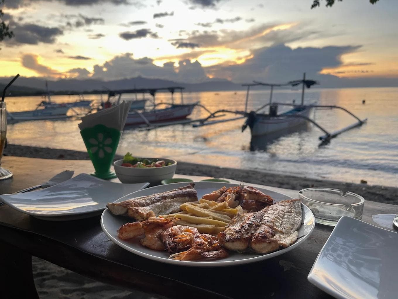Fresh grilled snapper on dry coconut husks at Warung Nemo beachfront Lovina